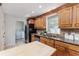 Well-lit kitchen features granite counters, stainless steel appliances, and wood cabinetry at 4059 The Fenway, Mulberry, FL 33860