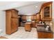 Traditional-style kitchen with wood cabinetry, granite countertops, stainless steel appliances, and a functional island at 4059 The Fenway, Mulberry, FL 33860