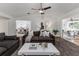 Spacious living room with vaulted ceilings, neutral decor, plush seating, and seamless flow to dining area at 4059 The Fenway, Mulberry, FL 33860