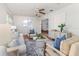 Well-lit living area featuring hardwood floors, neutral-toned furniture, and seamless integration with other living spaces at 4059 The Fenway, Mulberry, FL 33860