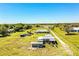 Aerial view of the expansive rural property featuring several outbuildings and long private drive at 408 Old Bartow Lake Wales Rd, Bartow, FL 33830