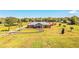 Aerial view of charming house with vast green lawn and metal roof at 408 Old Bartow Lake Wales Rd, Bartow, FL 33830