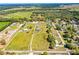 An aerial view of the expansive property showcasing the house, surrounding fields, and lush landscaping, providing privacy at 408 Old Bartow Lake Wales Rd, Bartow, FL 33830