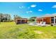 A backyard featuring a shed, patio with seating, and lush green lawn at 408 Old Bartow Lake Wales Rd, Bartow, FL 33830