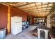 Covered outdoor area on the barn interior featuring a fridge, table and chairs, and ample workspace at 408 Old Bartow Lake Wales Rd, Bartow, FL 33830