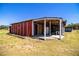 Exterior shot of the charming barn with a lean-to, showcasing the expansive outdoor storage on the property at 408 Old Bartow Lake Wales Rd, Bartow, FL 33830