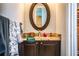 Bathroom vanity with granite countertop, oval mirror, and bronze fixtures adds classic elegance at 408 Old Bartow Lake Wales Rd, Bartow, FL 33830