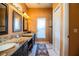 Spacious bathroom featuring double sinks, granite countertops, framed mirrors, and a walk-in shower at 408 Old Bartow Lake Wales Rd, Bartow, FL 33830