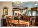 Elegant dining room featuring a chandelier, wooden table with ornate chairs, and an open view to the kitchen at 408 Old Bartow Lake Wales Rd, Bartow, FL 33830