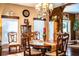 Charming dining room featuring a wooden table, ornate chairs, chandelier, and ample natural light at 408 Old Bartow Lake Wales Rd, Bartow, FL 33830