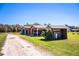 Property featuring covered parking, shed, and barn on a vast lot surrounded by greenery at 408 Old Bartow Lake Wales Rd, Bartow, FL 33830