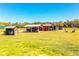 Expansive property featuring barn with parking, shed and grassy surroundings under a clear sky at 408 Old Bartow Lake Wales Rd, Bartow, FL 33830