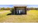 Outdoor shed featuring metal roof, wooden siding, and utilities hookups on a grassy lot at 408 Old Bartow Lake Wales Rd, Bartow, FL 33830