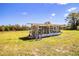 A backyard greenhouse bathed in natural light and surrounded by a sprawling lawn, ideal for cultivating plants and flowers at 408 Old Bartow Lake Wales Rd, Bartow, FL 33830