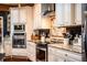 Close up of kitchen with white cabinets, stainless appliances, and decorative backsplash at 408 Old Bartow Lake Wales Rd, Bartow, FL 33830