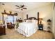 Traditional main bedroom with a four-poster bed, ceiling fan and unique decor accents at 408 Old Bartow Lake Wales Rd, Bartow, FL 33830