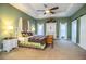 Bright main bedroom featuring a canopy bed, wooden floors, and ample natural light at 408 Old Bartow Lake Wales Rd, Bartow, FL 33830