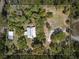 Aerial view of the property highlighting the wooded lot and structures at 4410 Rushing Rd, Lakeland, FL 33810