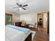 Bedroom featuring wood floors, ceiling fan, and sitting area with chairs at 4410 Rushing Rd, Lakeland, FL 33810