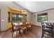 Dining room with wood floors, large windows, and seating for six, perfect for Gathering meals at 4410 Rushing Rd, Lakeland, FL 33810