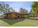 Inviting exterior with wood siding, covered porch, and carport in a lush setting at 4410 Rushing Rd, Lakeland, FL 33810