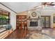 Elegant living room featuring a stone fireplace, wood floors, and a bookshelf for a cozy and stylish atmosphere at 4410 Rushing Rd, Lakeland, FL 33810