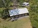 Aerial view of a four-car garage/outbuilding surrounded by mature trees on a grassy lot at 4410 Rushing Rd, Lakeland, FL 33810