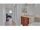 View of bathroom with tile floors, tub, sink with wood cabinets, and connection to bedroom at 4512 Brookshire Pl, Lake Wales, FL 33898