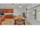 Dining area with a long wooden table, six chairs, tile floors, and bright light from the window at 4512 Brookshire Pl, Lake Wales, FL 33898