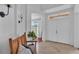 Bright foyer featuring neutral tile floors, a rustic bench, and a view of the front yard at 4512 Brookshire Pl, Lake Wales, FL 33898