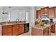 Kitchen features granite countertops, wooden cabinets, a black dishwasher, and stainless steel appliances at 4512 Brookshire Pl, Lake Wales, FL 33898