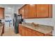 Extended granite countertop space in kitchen alongside stainless appliances and wood cabinetry at 4512 Brookshire Pl, Lake Wales, FL 33898