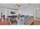 Relaxing living room with a large TV, white walls, hardwood floors, and gray furniture at 4512 Brookshire Pl, Lake Wales, FL 33898