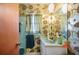 Well-lit bathroom with a flower wallpaper, a single sink vanity, and a shower at 4908 S Bedford Ln, Lakeland, FL 33813