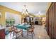 Open concept dining area featuring a chandelier, connected to the kitchen and living area at 4908 S Bedford Ln, Lakeland, FL 33813