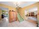 View of a classic foyer featuring tile flooring, patterned wallpaper, a staircase and access to the living spaces at 4908 S Bedford Ln, Lakeland, FL 33813