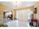 Classic foyer view featuring tile flooring, patterned wallpaper, a staircase and views into the living areas at 4908 S Bedford Ln, Lakeland, FL 33813