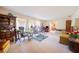 A spacious living room featuring carpeted floors, ample seating and natural light from the large windows at 4908 S Bedford Ln, Lakeland, FL 33813