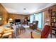 Cozy living room featuring wood paneling, comfortable seating, and natural light at 4908 S Bedford Ln, Lakeland, FL 33813