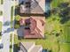 Bird's eye view of a single-Gathering home with a red tile roof, manicured lawn and lush landscape at 4929 Tennessee Lake Dr, Auburndale, FL 33823