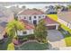 Stunning aerial view of a luxurious home with a red tile roof, lush landscaping, and a paver driveway at 4929 Tennessee Lake Dr, Auburndale, FL 33823