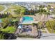 Aerial view of the community pool, clubhouse, playground, and manicured landscaping at 4929 Tennessee Lake Dr, Auburndale, FL 33823