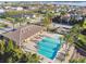 Aerial view of community pool, clubhouse, playground and lake in the distance at 4929 Tennessee Lake Dr, Auburndale, FL 33823