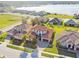 Stunning aerial view of homes, showcasing manicured lawns, and the lake at 4929 Tennessee Lake Dr, Auburndale, FL 33823