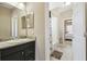 Bathroom featuring a granite counter and a view through the doorway to the bath and bedroom at 4929 Tennessee Lake Dr, Auburndale, FL 33823