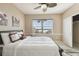 Bedroom features a ceiling fan, lake view, and closet at 4929 Tennessee Lake Dr, Auburndale, FL 33823