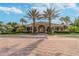 Beautiful community clubhouse framed by mature palm trees and lush landscaping in a serene setting at 4929 Tennessee Lake Dr, Auburndale, FL 33823