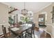 Open concept dining area with dark wood table and chairs, chandelier, and hardwood floors at 4929 Tennessee Lake Dr, Auburndale, FL 33823