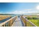 Picturesque waterfront view from a wooden dock with railing on a sunny day at 4929 Tennessee Lake Dr, Auburndale, FL 33823