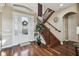 Elegant foyer with a decorative glass front door, wood staircase, and hardwood floors at 4929 Tennessee Lake Dr, Auburndale, FL 33823